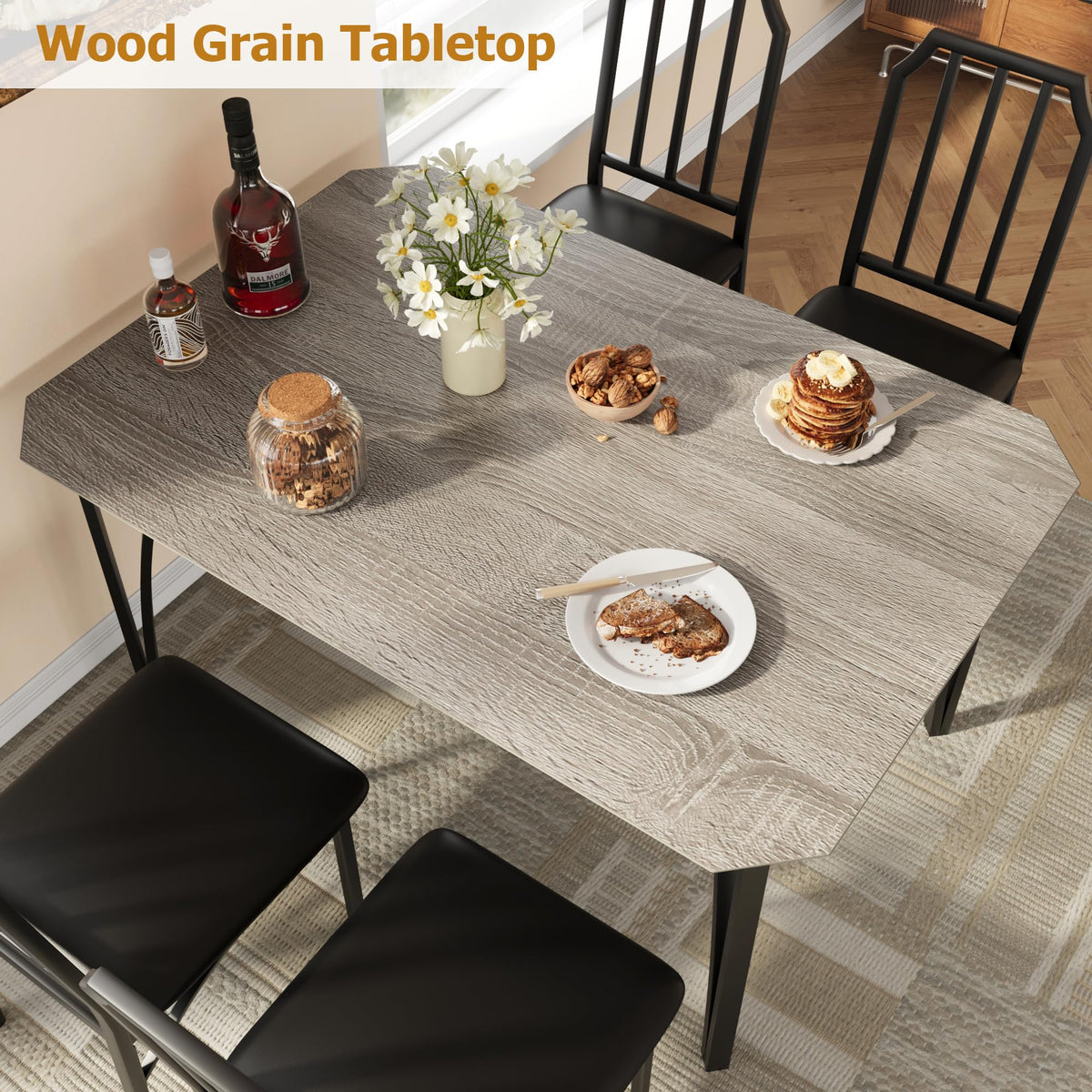 Ensemble table et chaises Garvee pour 4 personnes, design biseauté, coussins d'assise en polyuréthane, structure en MDF et acier, compact et robuste, idéal pour les petits espaces, noir.